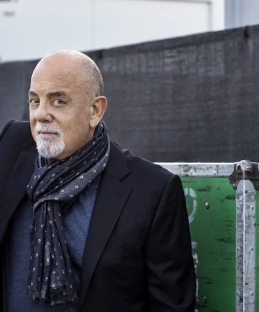 Billy Joel smiles at the camera